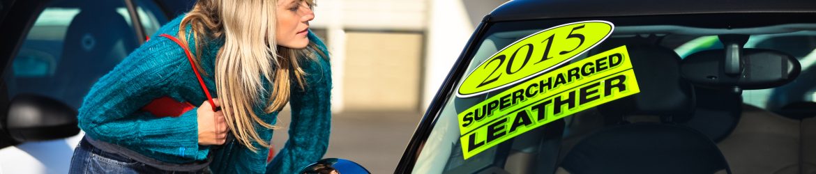 Young woman shopping for a used car